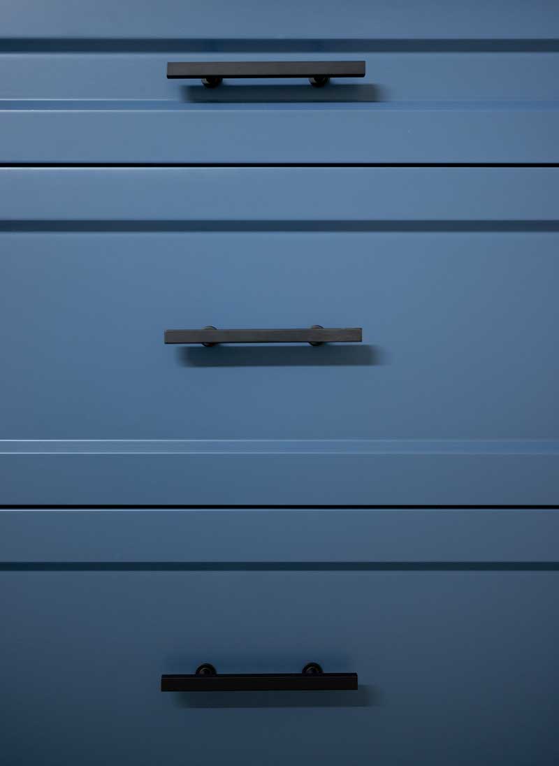 Painted navy blue cabinet drawers with black hardware – kitchen cabinet repainting near me